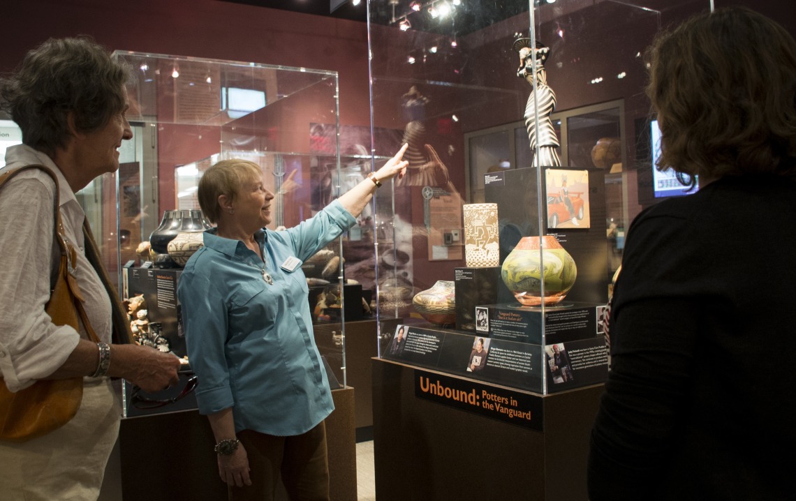 Docents point out important details in the exhibits